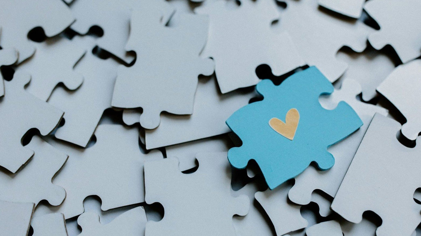 Jigsaw Puzzles for Adults - Blue jigsaw puzzle piece with a yellow heart